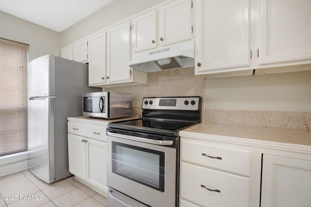 210 Long Plantation Blvd Unit U, Lafayette, LA 70508 - kitchen with appliances with stainless steel finishes, under cabinet range hood, light countertops, white cabinets, and light tile patterned floors