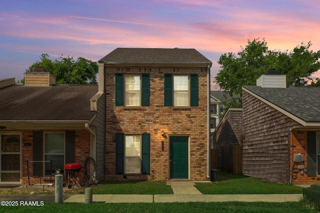 210 Long Plantation Blvd Unit U, Lafayette, LA 70508 - view of front facade featuring brick siding, a chimney, and a shingled roof