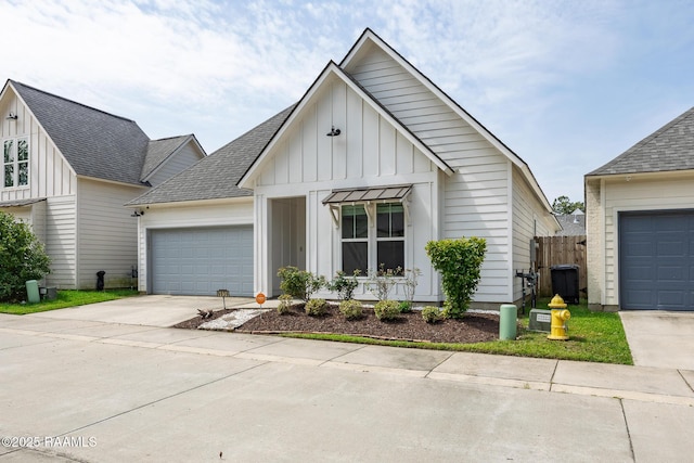 9036 Stonecroft Ave, Baton Rouge, LA 70810 - view of front of property with board and batten siding, driveway, a garage, and a shingled roof