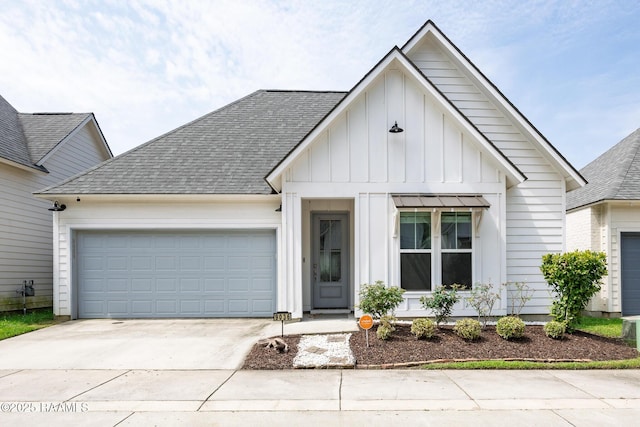 9036 Stonecroft Ave, Baton Rouge, LA 70810 - view of front facade featuring board and batten siding, driveway, an attached garage, and roof with shingles