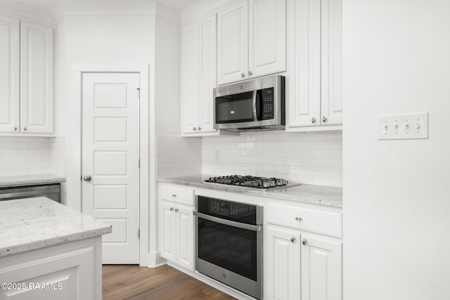 9036 Stonecroft Ave, Baton Rouge, LA 70810 - kitchen featuring appliances with stainless steel finishes, white cabinets, backsplash, light wood-style floors, and light stone countertops