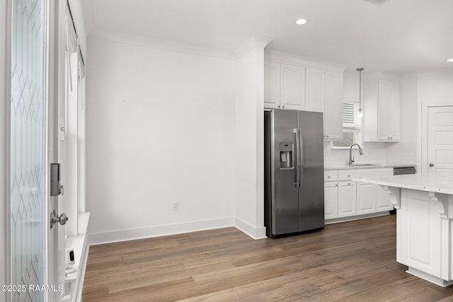 9036 Stonecroft Ave, Baton Rouge, LA 70810 - kitchen with stainless steel refrigerator with ice dispenser, a sink, white cabinets, recessed lighting, and wood finished floors