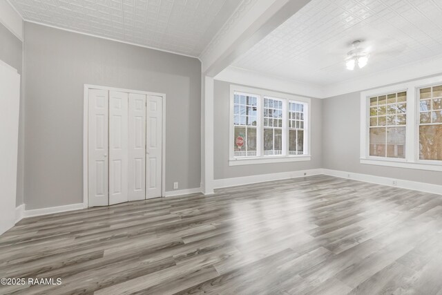1323 Tarleton, Jeanerette, LA 70544 - unfurnished living room featuring wood finished floors, ceiling fan, baseboards, and crown molding