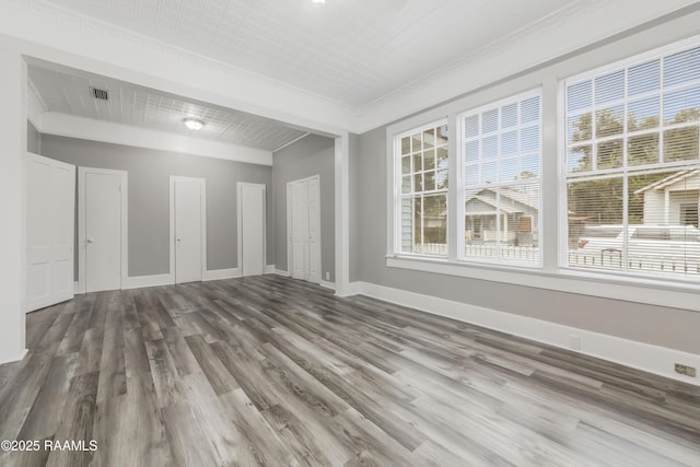 1323 Tarleton, Jeanerette, LA 70544 - unfurnished room featuring healthy amount of natural light, wood finished floors, ornamental molding, and baseboards