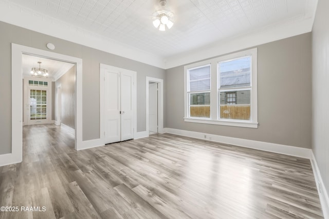 1323 Tarleton, Jeanerette, LA 70544 - unfurnished bedroom with a chandelier, wood finished floors, crown molding, and baseboards