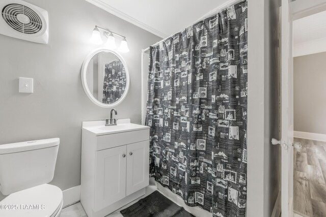 1323 Tarleton, Jeanerette, LA 70544 - bathroom featuring toilet, vanity, ornamental molding, baseboards, and a shower with shower curtain