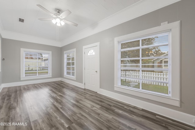 1323 Tarleton, Jeanerette, LA 70544 - unfurnished living room with ornamental molding, plenty of natural light, a ceiling fan, and dark wood-style floors