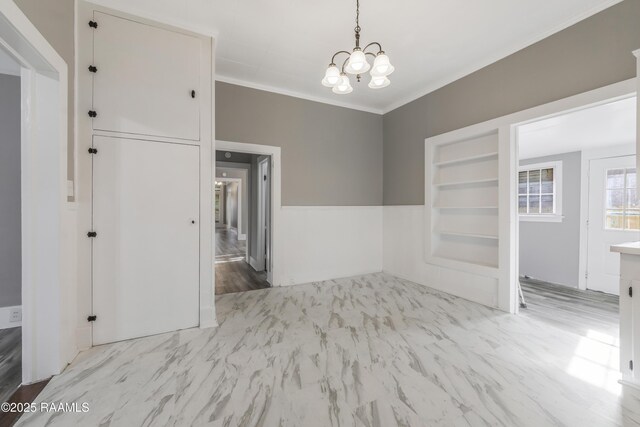 1323 Tarleton, Jeanerette, LA 70544 - unfurnished dining area featuring a chandelier, ornamental molding, and built in features
