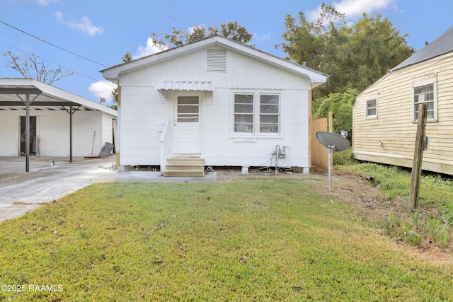 1323 Tarleton, Jeanerette, LA 70544 - back of house featuring a lawn, entry steps, and a detached carport