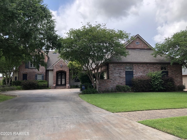 103 Masterspoint Dr, Broussard, LA 70518 - view of front of property with brick siding, french doors, driveway, a front lawn, and roof with shingles