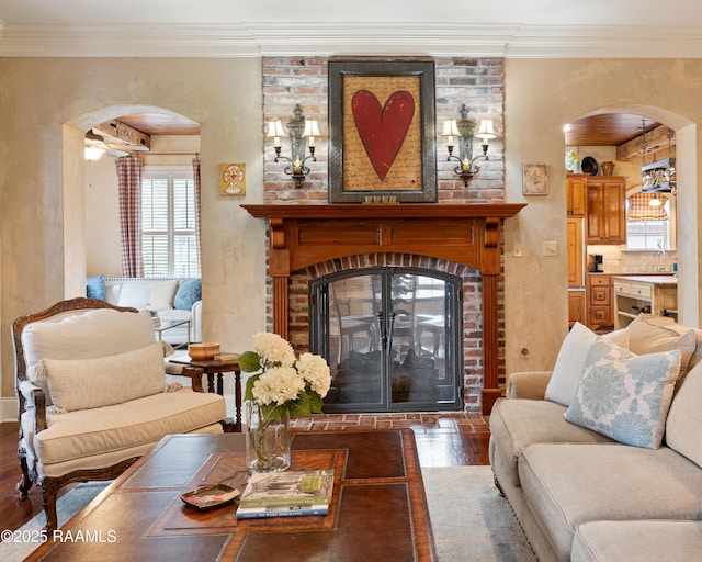 103 Masterspoint Dr, Broussard, LA 70518 - living room with arched walkways, a fireplace, wood finished floors, and crown molding