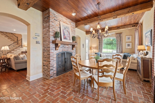 103 Masterspoint Dr, Broussard, LA 70518 - dining space with wood ceiling with exposed beams, brick floors, a fireplace, arched walkways, and stairway