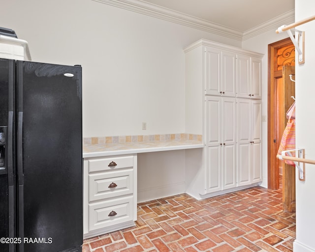 103 Masterspoint Dr, Broussard, LA 70518 - kitchen with black fridge with ice dispenser, brick floors, light countertops, white cabinetry, and ornamental molding