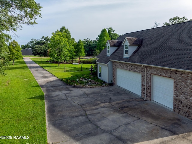 40400 Abby James Rd, Prairieville, LA 70769 - view of side of property with concrete driveway, a lawn, an attached garage, and brick siding