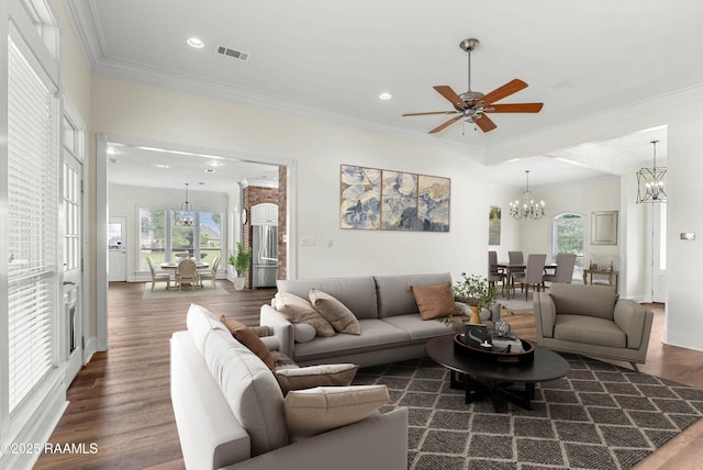 40400 Abby James Rd, Prairieville, LA 70769 - living room with plenty of natural light, a chandelier, wood finished floors, a ceiling fan, and ornamental molding