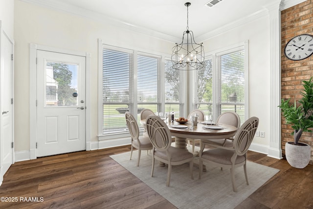 40400 Abby James Rd, Prairieville, LA 70769 - dining area featuring a chandelier, dark wood-type flooring, baseboards, and crown molding