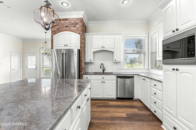 40400 Abby James Rd, Prairieville, LA 70769 - kitchen with stainless steel appliances, healthy amount of natural light, stone countertops, a sink, and crown molding