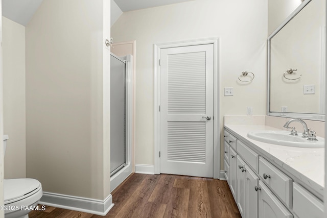 40400 Abby James Rd, Prairieville, LA 70769 - full bathroom with a shower stall, wood finished floors, vanity, toilet, and baseboards