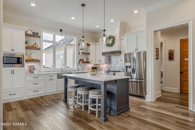 117 Big Lake Run, Youngsville, LA 70592 - kitchen with open shelves, appliances with stainless steel finishes, white cabinetry, a kitchen island, and light countertops
