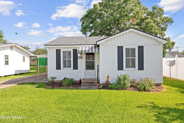 1617 Oscar St, Abbeville, LA 70510 - bungalow-style home with entry steps, roof with shingles, driveway, a carport, and board and batten siding