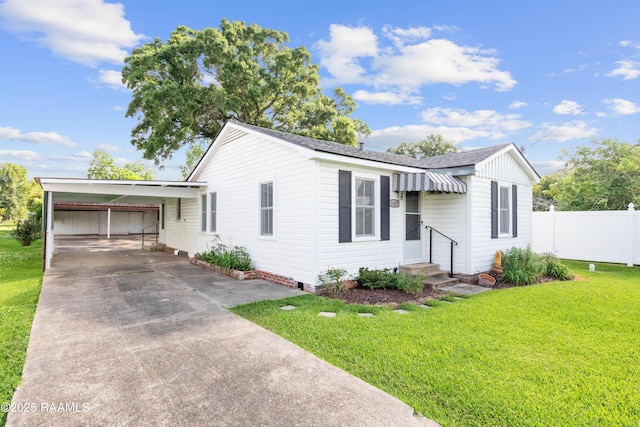 1617 Oscar St, Abbeville, LA 70510 - ranch-style home featuring concrete driveway, roof with shingles, an attached carport, and entry steps