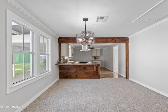 1617 Oscar St, Abbeville, LA 70510 - dining room featuring light carpet, a chandelier, baseboards, and crown molding