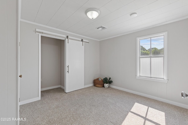 1617 Oscar St, Abbeville, LA 70510 - spare room with a barn door, carpet, crown molding, a smoke detector, and baseboards