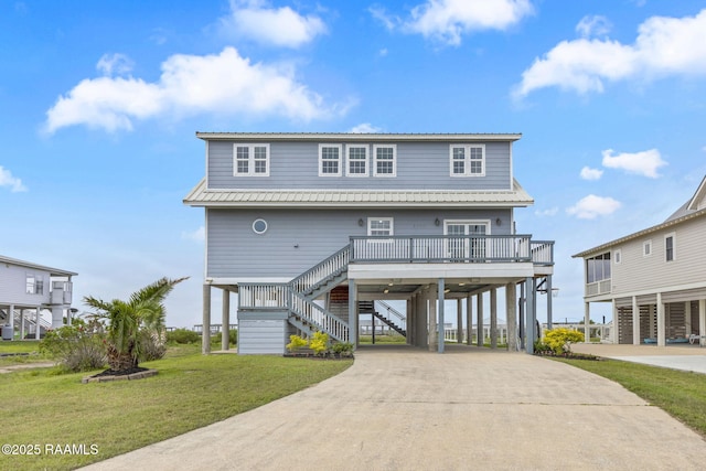 3785 Lake Breeze Rd, Lake Charles, LA 70605 - raised beach house with a carport, stairs, driveway, and a front yard