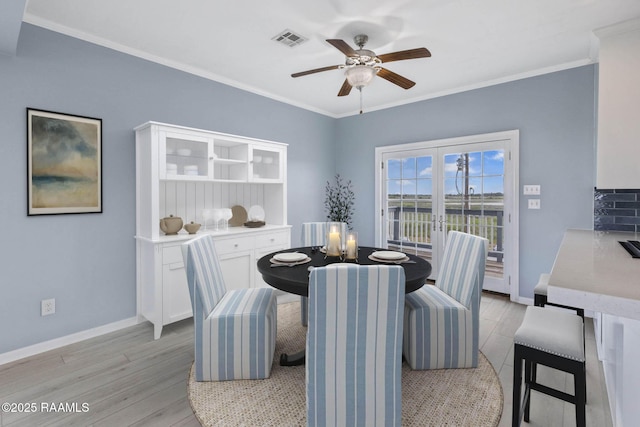 3785 Lake Breeze Rd, Lake Charles, LA 70605 - dining space with a ceiling fan, light wood-type flooring, crown molding, and baseboards