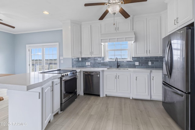 3785 Lake Breeze Rd, Lake Charles, LA 70605 - kitchen with stainless steel appliances, ceiling fan, a sink, a peninsula, and white cabinetry