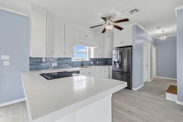 3785 Lake Breeze Rd, Lake Charles, LA 70605 - kitchen with stainless steel fridge with ice dispenser, a sink, a peninsula, baseboards, and ornamental molding