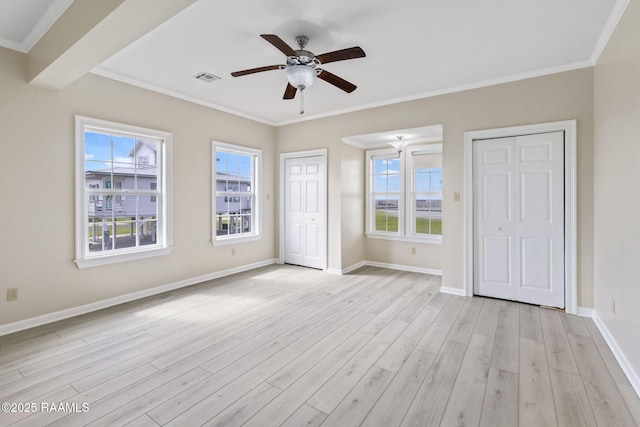 3785 Lake Breeze Rd, Lake Charles, LA 70605 - unfurnished bedroom featuring multiple closets, multiple windows, light wood finished floors, and crown molding