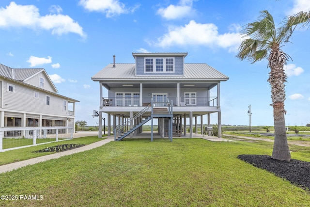 3785 Lake Breeze Rd, Lake Charles, LA 70605 - coastal inspired home featuring covered porch, a front lawn, metal roof, and stairs