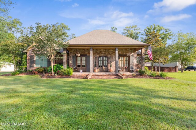 124 Edmund Ln, Eunice, LA 70535 - view of front of house with french doors, a front yard, and brick siding