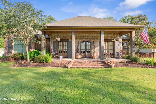 124 Edmund Ln, Eunice, LA 70535 - back of property featuring french doors, brick siding, a lawn, and a patio
