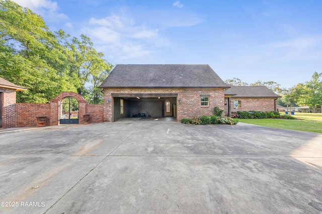 124 Edmund Ln, Eunice, LA 70535 - view of property exterior featuring brick siding, a gate, driveway, and a garage