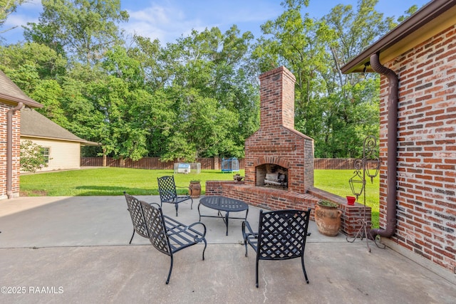124 Edmund Ln, Eunice, LA 70535 - view of patio with an outdoor brick fireplace