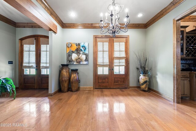124 Edmund Ln, Eunice, LA 70535 - entryway with french doors, crown molding, a chandelier, wood finished floors, and baseboards