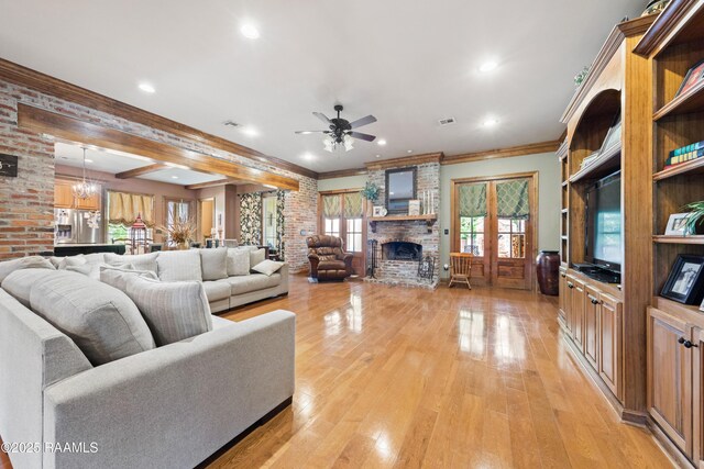 124 Edmund Ln, Eunice, LA 70535 - living area with a fireplace, ceiling fan, light wood finished floors, recessed lighting, and french doors