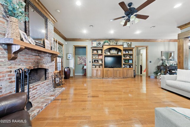124 Edmund Ln, Eunice, LA 70535 - living room with ornamental molding, ceiling fan, baseboards, a brick fireplace, and light wood-style floors