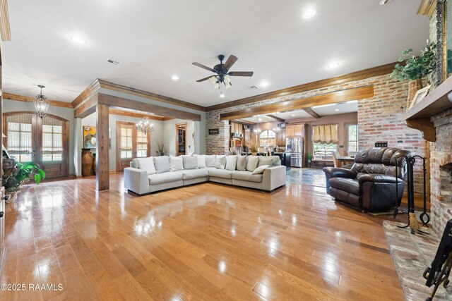 124 Edmund Ln, Eunice, LA 70535 - living area featuring a chandelier, a ceiling fan, light wood-type flooring, ornamental molding, and recessed lighting