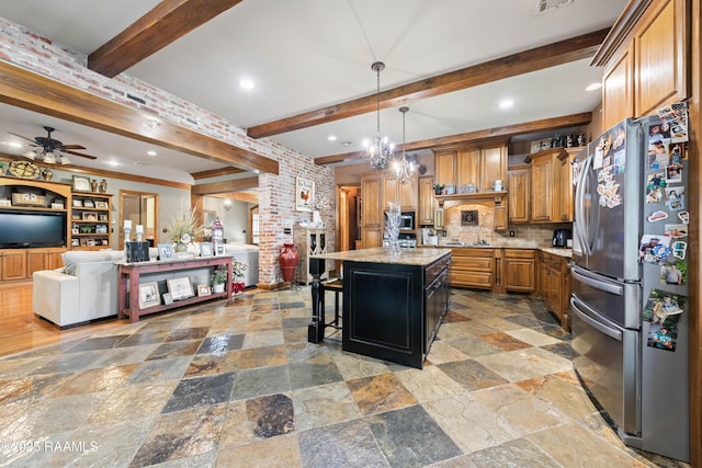 124 Edmund Ln, Eunice, LA 70535 - kitchen featuring stainless steel appliances, beam ceiling, a ceiling fan, light stone countertops, and stone tile floors