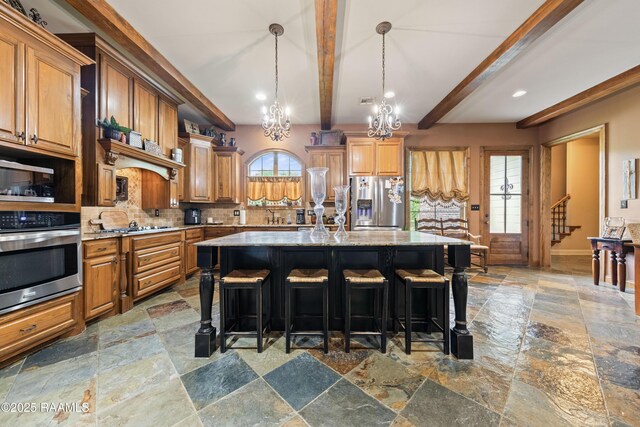 124 Edmund Ln, Eunice, LA 70535 - kitchen with appliances with stainless steel finishes, stone tile floors, a chandelier, backsplash, and beamed ceiling