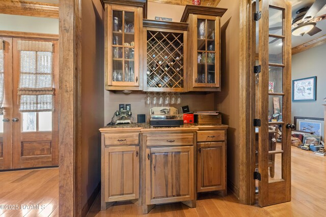 124 Edmund Ln, Eunice, LA 70535 - indoor dry bar with light wood finished floors, ornamental molding, a ceiling fan, and baseboards