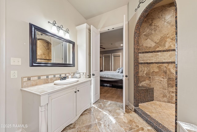 124 Edmund Ln, Eunice, LA 70535 - ensuite bathroom featuring vanity, tiled shower, and marble finish floors