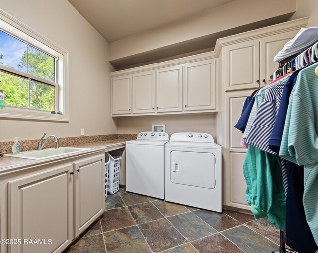 124 Edmund Ln, Eunice, LA 70535 - washroom with washer and dryer, cabinet space, and stone tile flooring