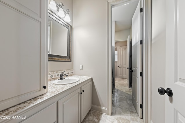 124 Edmund Ln, Eunice, LA 70535 - bathroom featuring baseboards, vanity, and backsplash