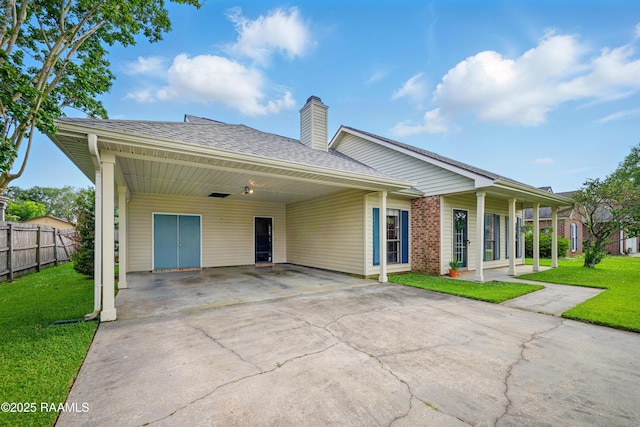 107 Westpointe Cir, Lafayette, LA 70506 - view of front of house featuring concrete driveway, a chimney, an attached carport, and a shingled roof