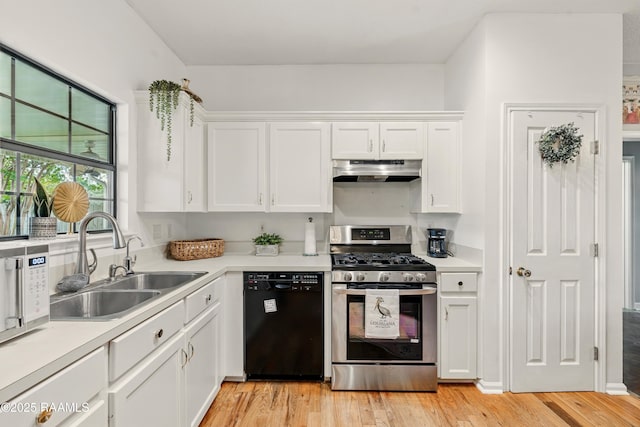 107 Westpointe Cir, Lafayette, LA 70506 - kitchen with dishwasher, stainless steel range with gas stovetop, under cabinet range hood, a sink, and white cabinets
