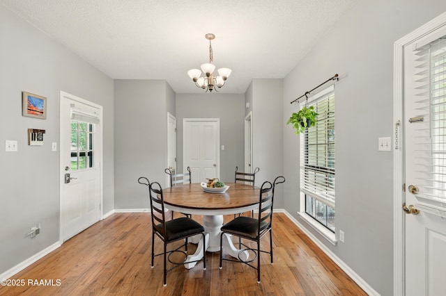 107 Westpointe Cir, Lafayette, LA 70506 - dining room with light wood-style flooring, a chandelier, and baseboards